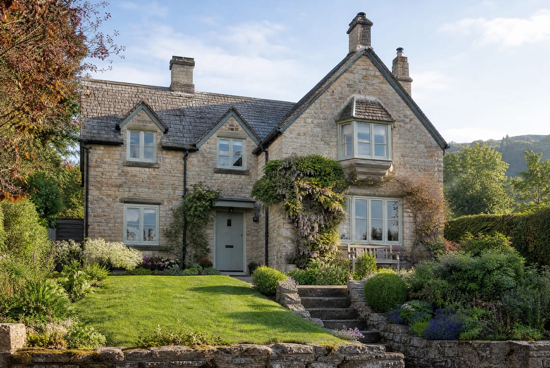 Detached stone house with a front garden