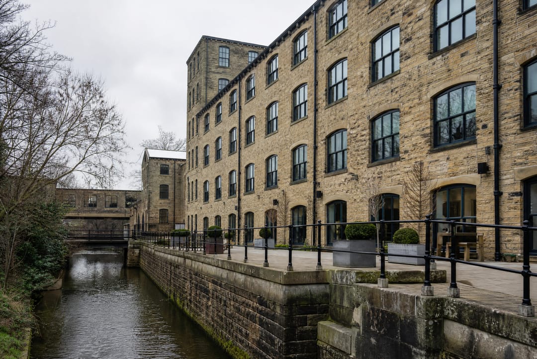 Converted stone mill building beside a canal