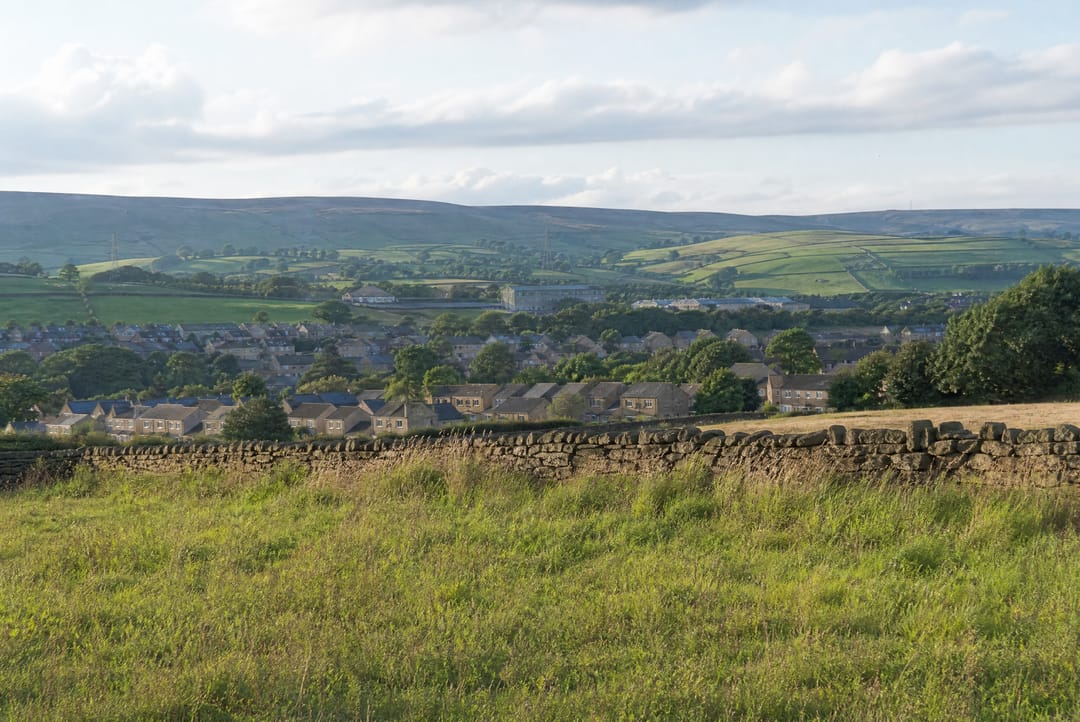 Green development land with a dry stone wall